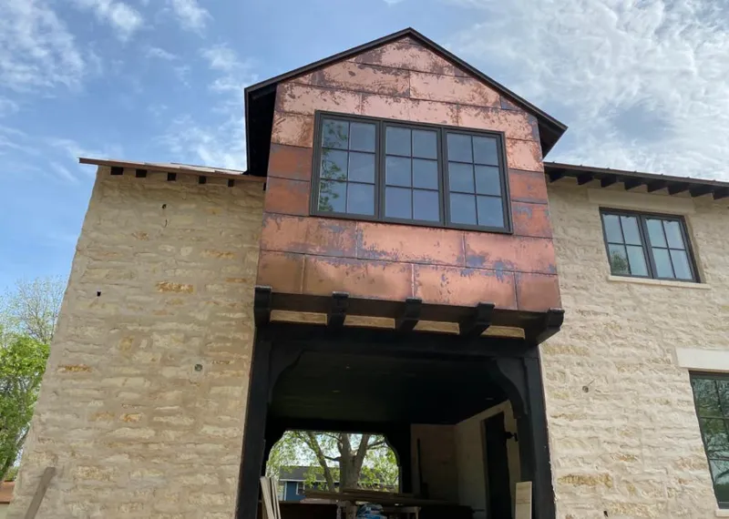 Copper metal panel facade on a stone building for Roof Repair in Santa Teresa