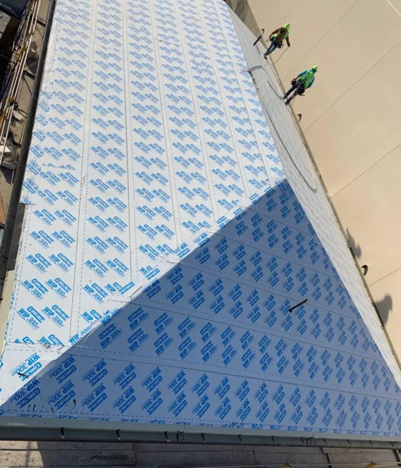 Professional roofers installing underlayment on a metal roof in Santa Teresa